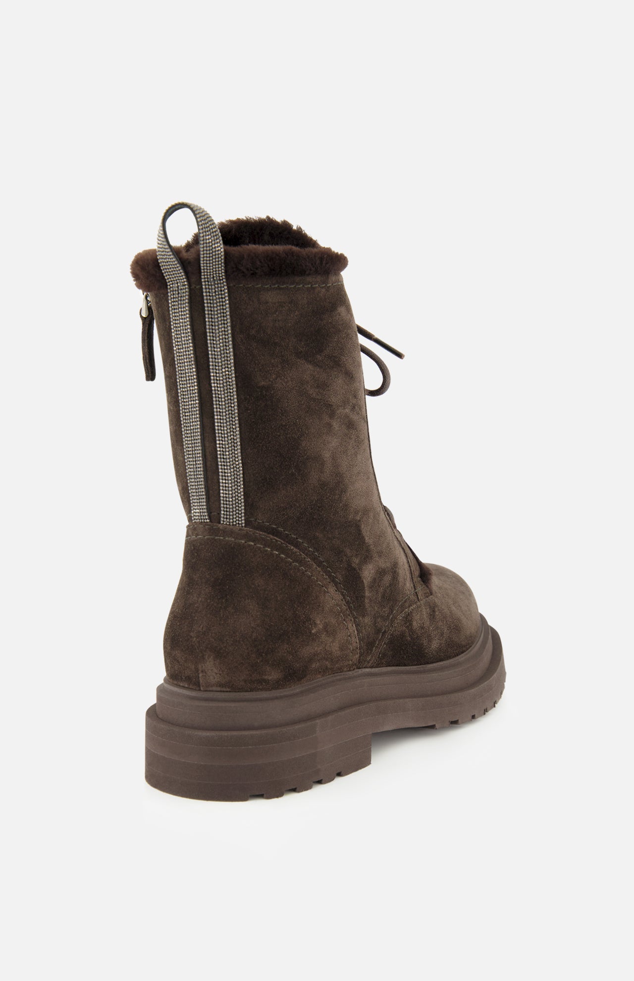 The BRUNELLO CUCINELLI Shearling Lined Lace Boot with Monili Tabs is crafted from luxurious dark chocolate brown suede, featuring a thick sole, lace-up front, and distinctive striped Monili pull tabs at the back. The pair is showcased from an angled rear view against a plain white background.
