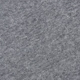 Close-up of a heather gray textured knit fabric with a subtle pattern, featuring part of the clothing label in the upper left corner, echoing the refined craftsmanship of the BRUNELLO CUCINELLI Silk Knitted Long Sleeve Sweater.