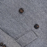 Close-up of the BRUNELLO CUCINELLI Sparkling Wool Herringbone Blazer in silver-grey, showing a lapel and part of the sleeve with four matching black buttons.
