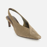 The Suede Wrap Slingback Heel by BRUNELLO CUCINELLI features a taupe suede finish, a pointed square toe, and a low heel, presented against a white background.
