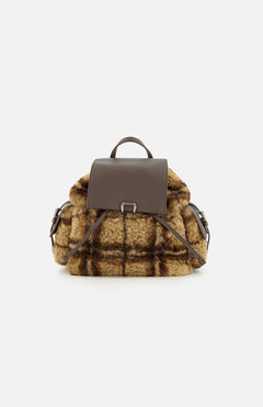 The BRUNELLO CUCINELLI Tartan Curly Shearling Backpack showcases a stylish design with a brown leather flap and handle, complemented by soft, curly yellow and brown plaid shearling in a classic tartan pattern on the main body and sides, all presented against a plain white background.