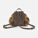 The BRUNELLO CUCINELLI Tartan Curly Shearling Backpack features brown leather construction, adjustable straps, a top handle, and plush brown fur accents on the sides. Photographed from the back against a white background, this stylish bag combines practicality with cozy shearling texture.