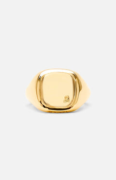 The BUNNEY Mini Cushion Signet Ring, crafted in yellow gold with a smooth, square-shaped face and a subtle hallmark near the edge, is displayed against a plain light background.