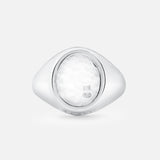 An Oval Signet Ring by BUNNEY, crafted in sterling silver with hallmark stamps and a textured white oval center, is shown against a plain light gray background.