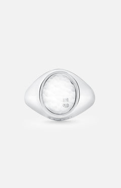 An Oval Signet Ring by BUNNEY, crafted in sterling silver with hallmark stamps and a textured white oval center, is shown against a plain light gray background.