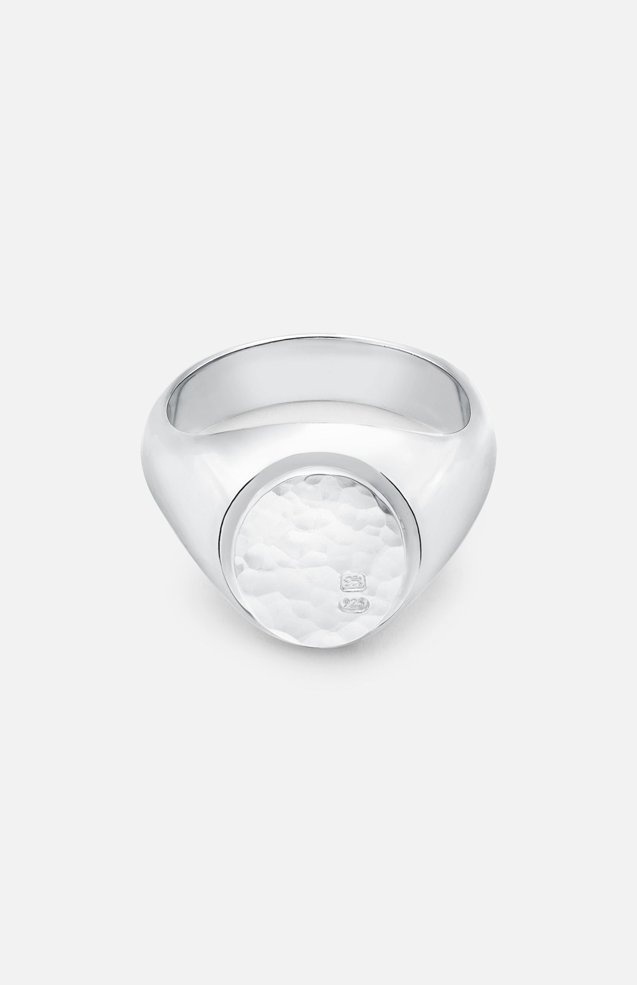 The BUNNEY Oval Signet Ring features a hammered, textured oval face with a subtle engraved logo, crafted in sterling silver in the handmade UK jewelry style, and is displayed on a plain white background.