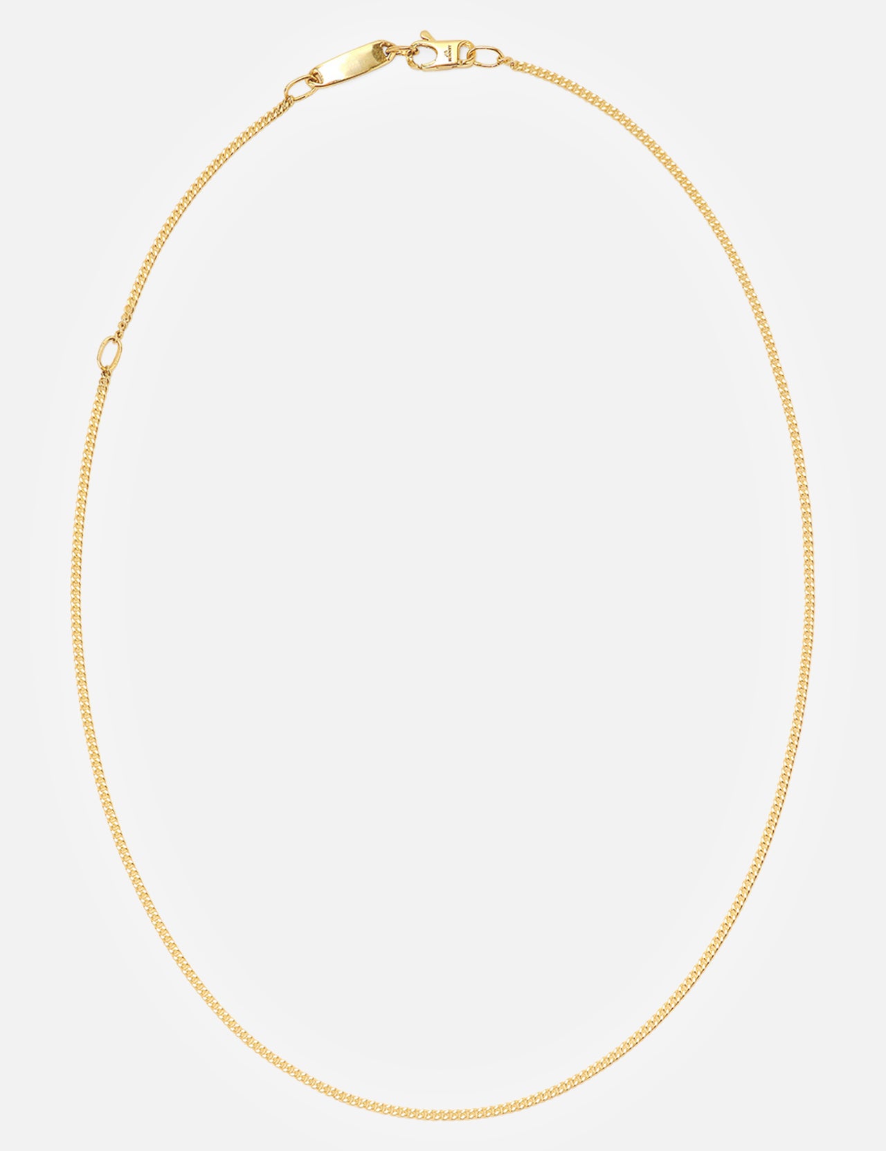 The BUNNEY Simple Chain Necklace 20" features a thin yellow gold design with a simple clasp, made in the UK and elegantly displayed in a circular form on a plain white background.