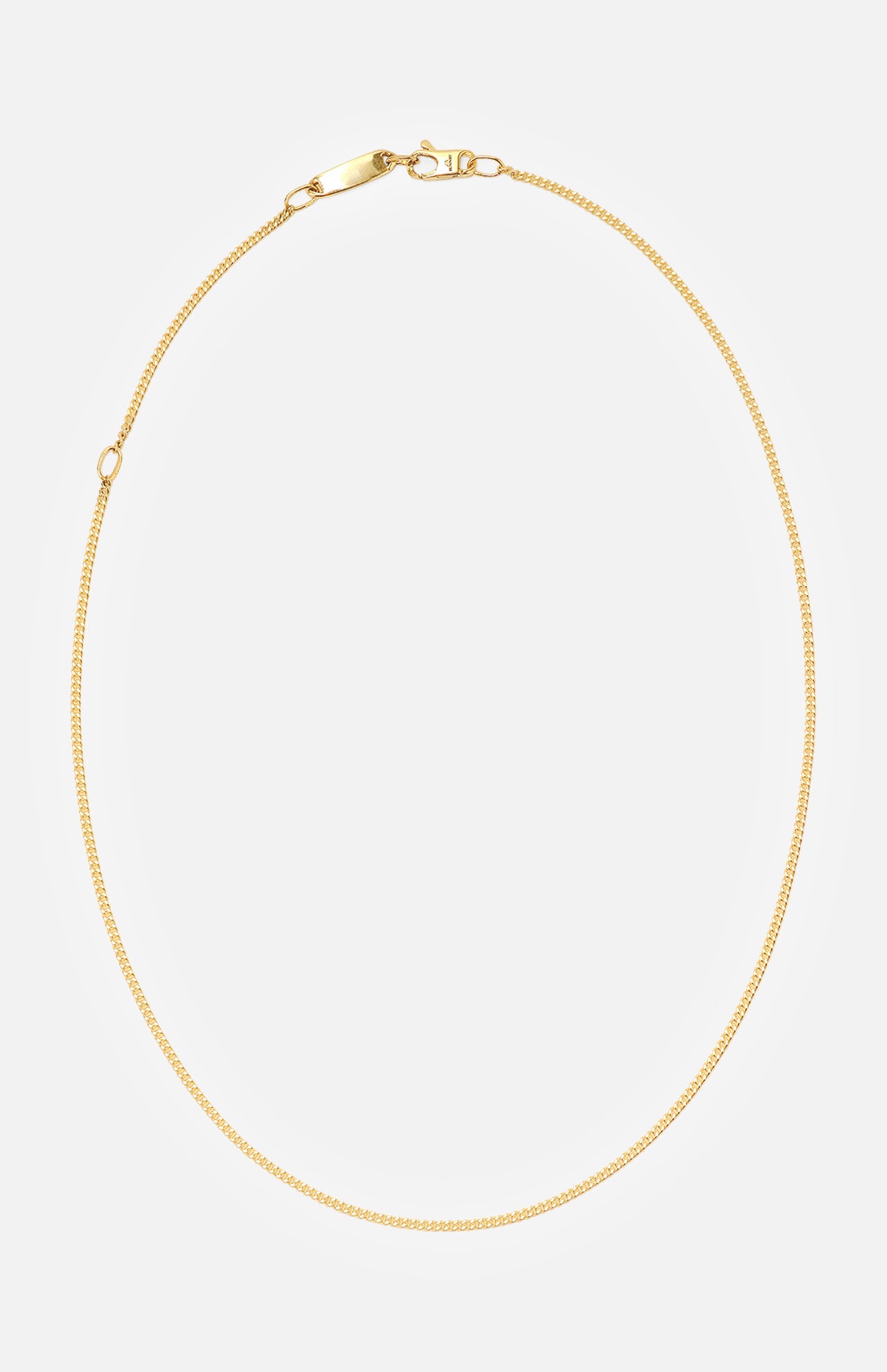 The BUNNEY Simple Chain Necklace 20" features a thin yellow gold design with a simple clasp, made in the UK and elegantly displayed in a circular form on a plain white background.