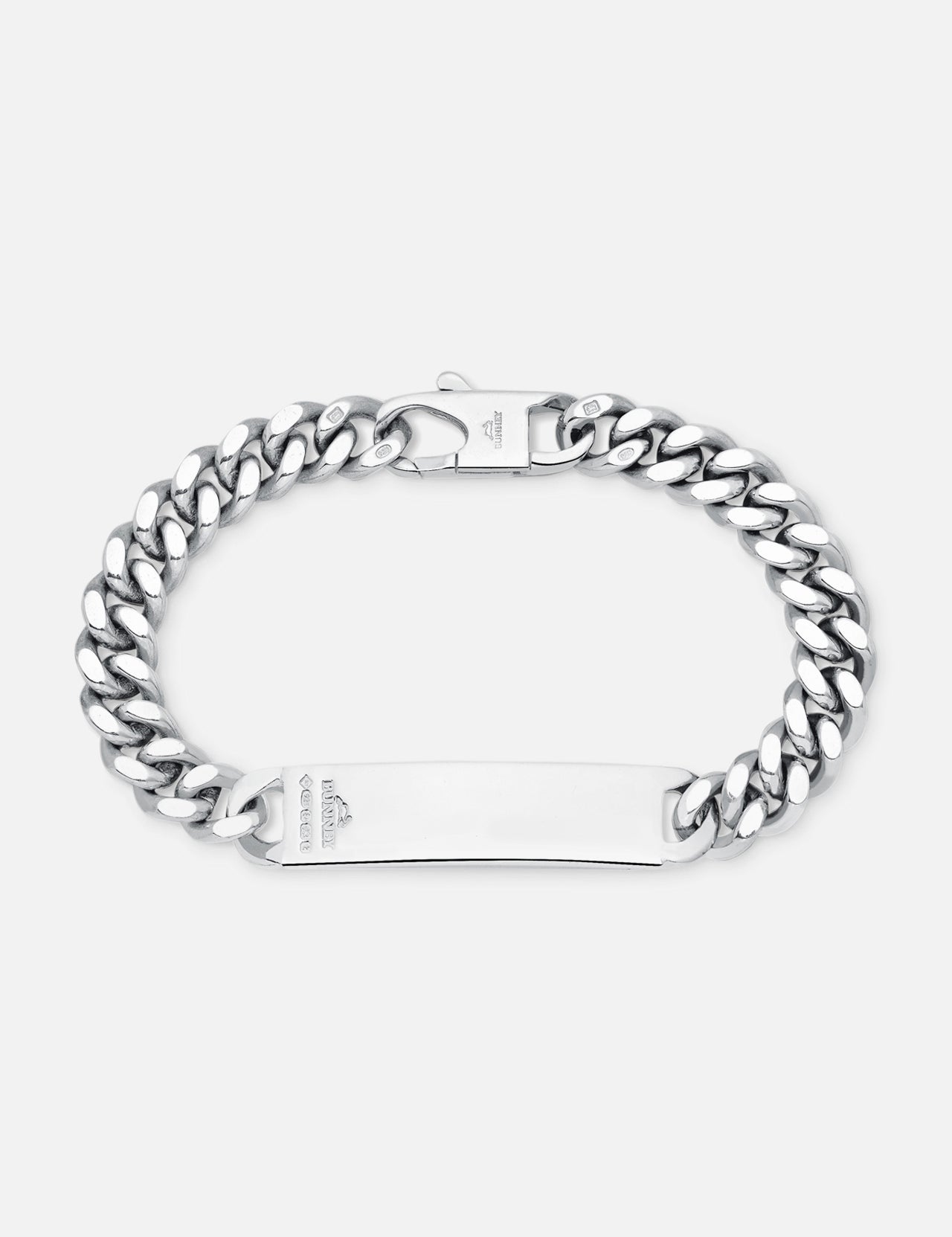 The BUNNEY Single Tour Identity Chain Bracelet features a flat, engraved logo plate, thick interlocking links, a clasp closure, and a polished sterling silver finish.