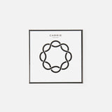 A minimalist artwork of a looping line in a circular pattern, reminiscent of the Carrie Purse Hook in Rose Gold. Above the design, "CARRIE ATELIER" is displayed on a white background.