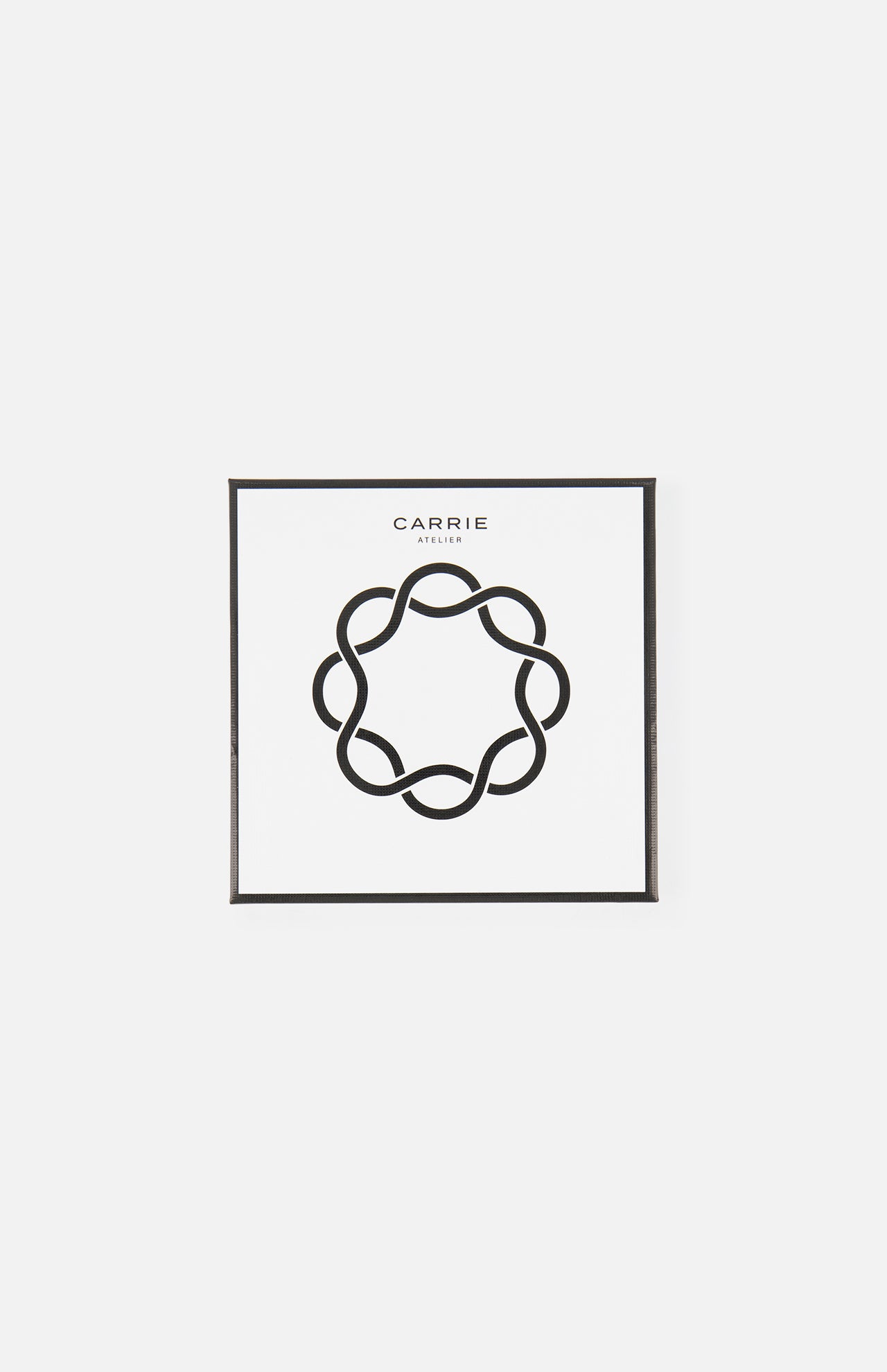 A minimalist artwork of a looping line in a circular pattern, reminiscent of the Carrie Purse Hook in Rose Gold. Above the design, "CARRIE ATELIER" is displayed on a white background.