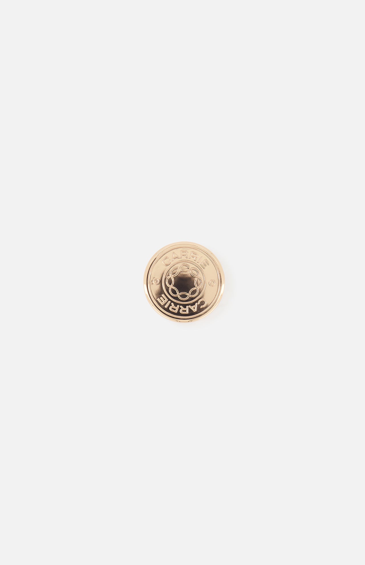 The Carrie Purse Hook in Rose Gold by CARRIE ATELIER is a round, rose gold metal pin engraved with a planet and stars plus "MARNI" along the edge. This stylish accessory doubles as an anti-slip bag holder, shown on a plain white background.