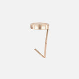 The CARRIE ATELIER Carrie Purse Hook in Rose Gold is a compact, portable bag holder with a round top and flat angled arm that keeps your handbag secure and clean by hanging it safely from any table.