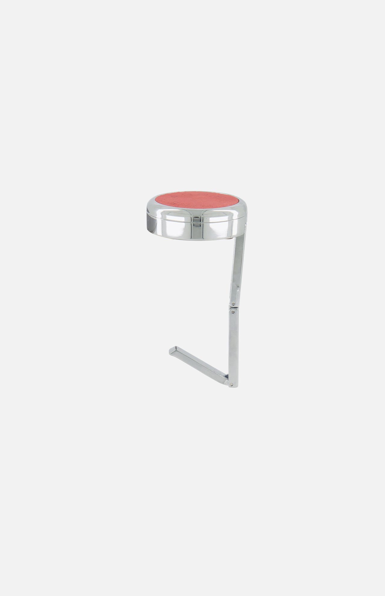 The Carrie Purse Hook Suede Etoile in Rose Eclipse by CARRIE ATELIER features a round pink seat and chrome frame in an L shape, doubling as a stylish purse hook to keep your designer bag off the floor, shown against a plain white background.