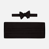 The CARROT & GIBBS Cummerbund Bowtie Set in sleek black satin is shown on a white background, ideal for elevating your formalwear style.