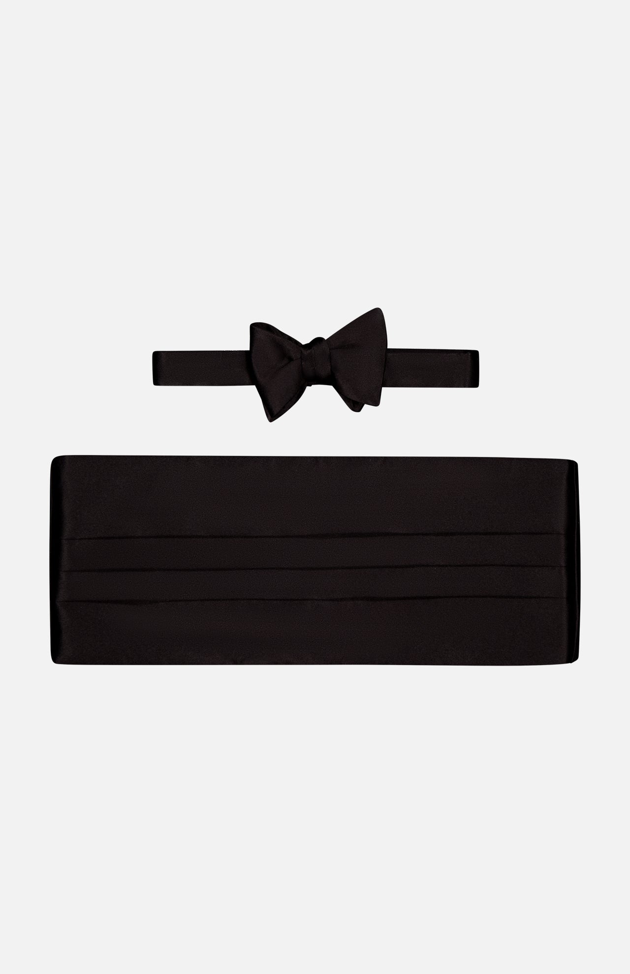 The CARROT & GIBBS Cummerbund Bowtie Set in sleek black satin is shown on a white background, ideal for elevating your formalwear style.