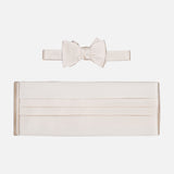 The CARROT & GIBBS Cummerbund Bowtie Set, shown on a white background, features classic horizontal pleats on the off-white satin cummerbund and a matching bowtie, both with a smooth, shiny finish.