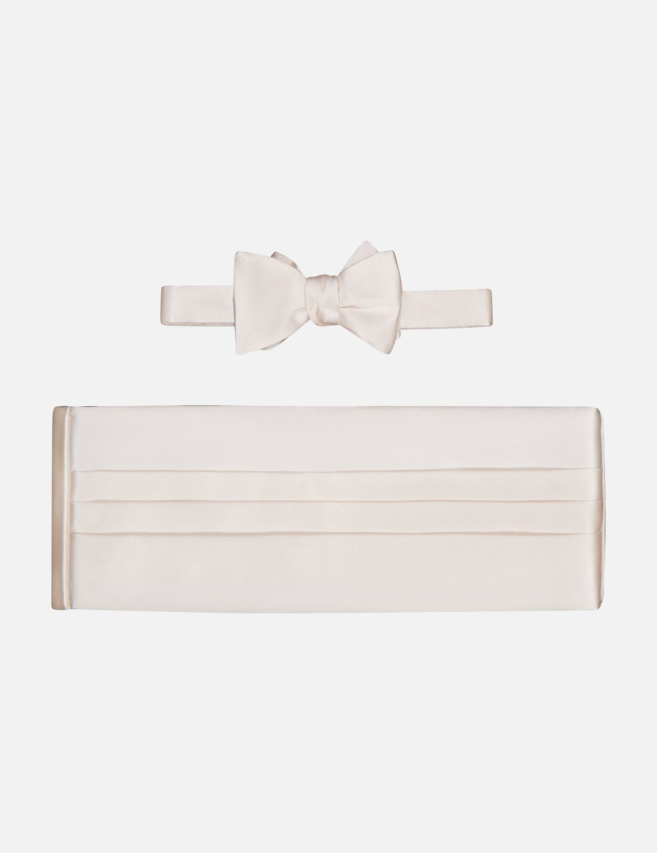 The CARROT & GIBBS Cummerbund Bowtie Set, shown on a white background, features classic horizontal pleats on the off-white satin cummerbund and a matching bowtie, both with a smooth, shiny finish.