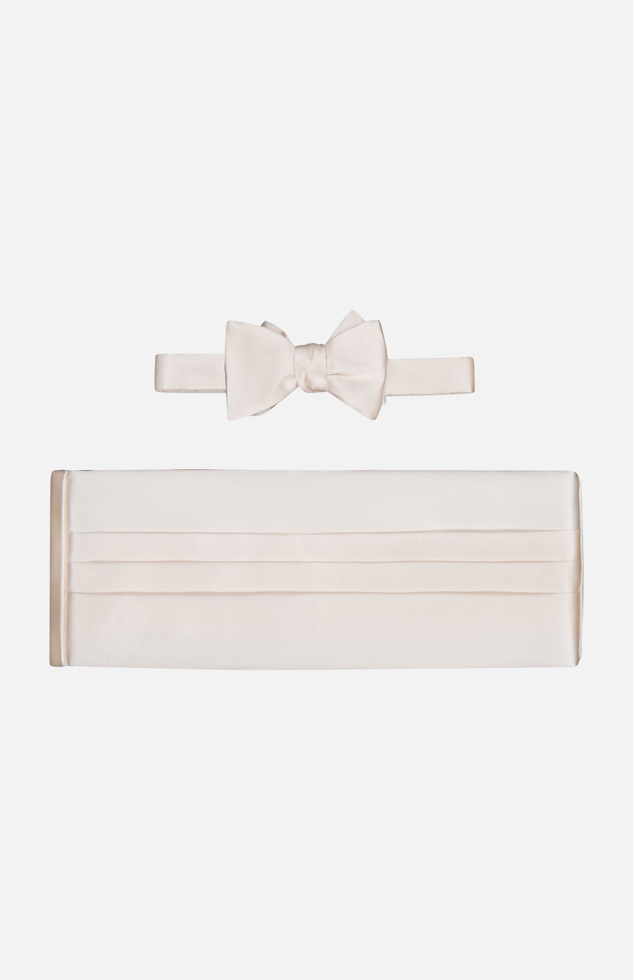 The CARROT & GIBBS Cummerbund Bowtie Set, shown on a white background, features classic horizontal pleats on the off-white satin cummerbund and a matching bowtie, both with a smooth, shiny finish.