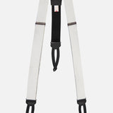A white and black "Satin Suspenders" by CARROT & GIBBS, featuring adjustable sliders and looped ends inspired by handcrafted suspenders, shown against a plain white background.