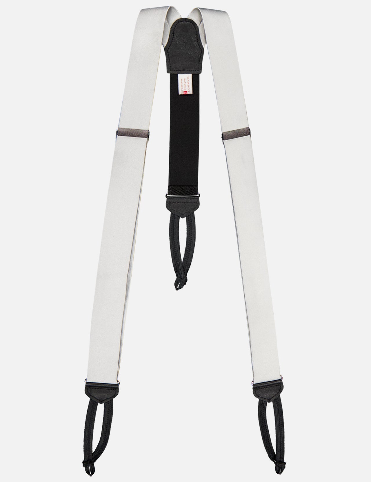 A white and black "Satin Suspenders" by CARROT & GIBBS, featuring adjustable sliders and looped ends inspired by handcrafted suspenders, shown against a plain white background.