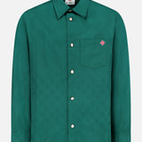 The CASABLANCA Piquet Logo Long Sleeve Shirt features a teal hue, classic collar, front chest pocket with a red and white embroidered patch, white buttons, and a subtle textured pattern.