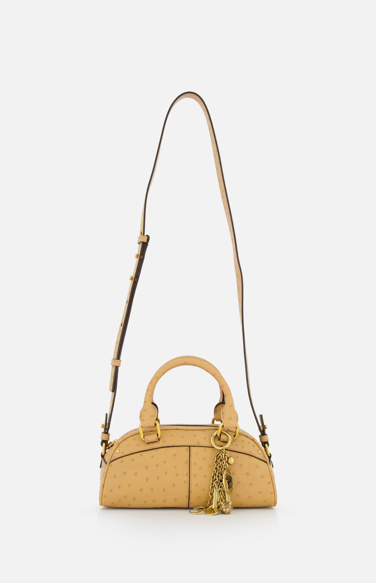 The Chloé Ostrich-effect Bowling Hand Bag by CHLOÉ is a tan, dome-shaped bag with gold hardware, a decorative gold chain accent, two handles, and an adjustable shoulder strap, shown against a plain white background.