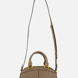The Chloé Bowling Hand Bag with Charms by CHLOÉ features taupe leather, gold hardware, two short handles, and an adjustable crossbody strap in a classic bowling silhouette, shown against a plain white background.