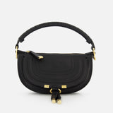 The CHLOÉ Marcie Mini Saddle Bag features black leather, gold hardware, a rounded silhouette, decorative front stitching, zipper closure, and a padded leather-wrapped handle—ideal as a chic crossbody for day or night.