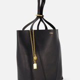 The CHLOÉ Spin Bag with Chain is a black leather handbag featuring a soft, unstructured shape, gold-tone logo, and decorative gold chain with a round charm and padlock detail, shown against a plain white background.