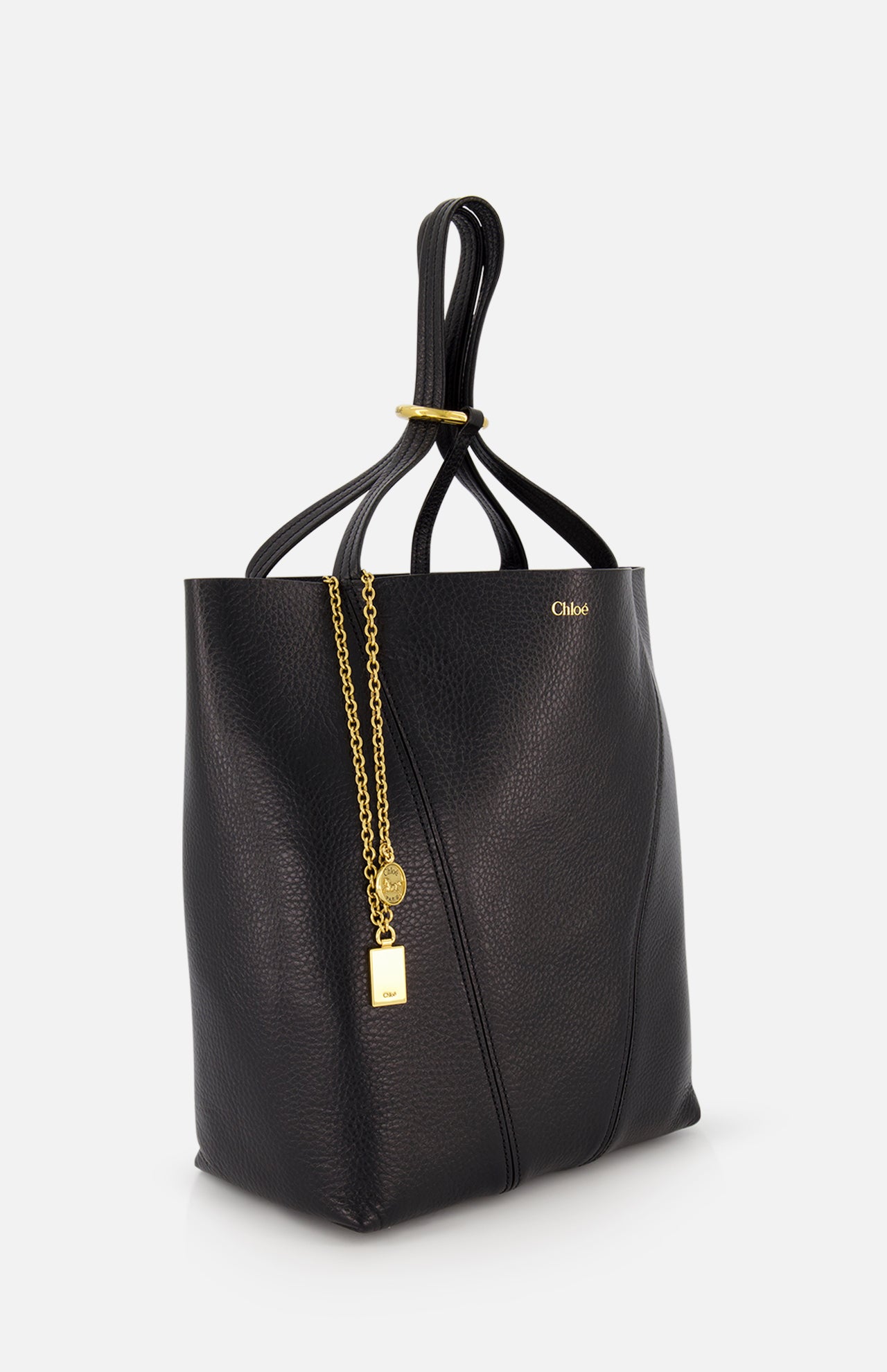 The CHLOÉ Spin Bag with Chain is a black leather handbag featuring a soft, unstructured shape, gold-tone logo, and decorative gold chain with a round charm and padlock detail, shown against a plain white background.