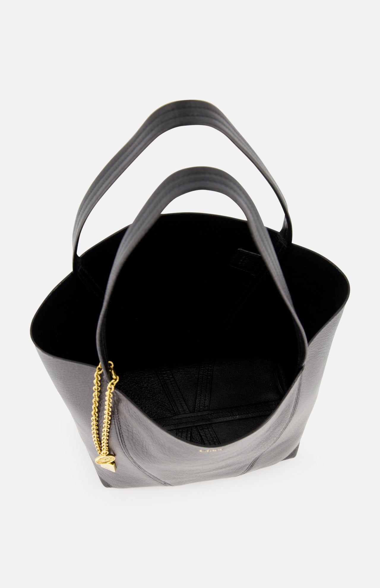 The CHLOÉ Spin Bag with Chain is a minimalist black leather designer handbag, shown from above with an open top and empty interior against a white background.