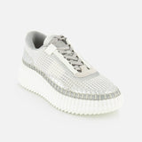 The CHLOÉ Metallized Nama Sneakers feature a textured gray and white woven upper, metallic details, and a chunky ridged recycled sole, shown angled on a light background for a modern luxe athleisure look.