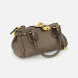 A CHLOÉ Paddington Shoulder Bag in brown buffalo leather with gold hardware, double handles, decorative buckle accents, and a clasp closure, shown on a plain white background.
