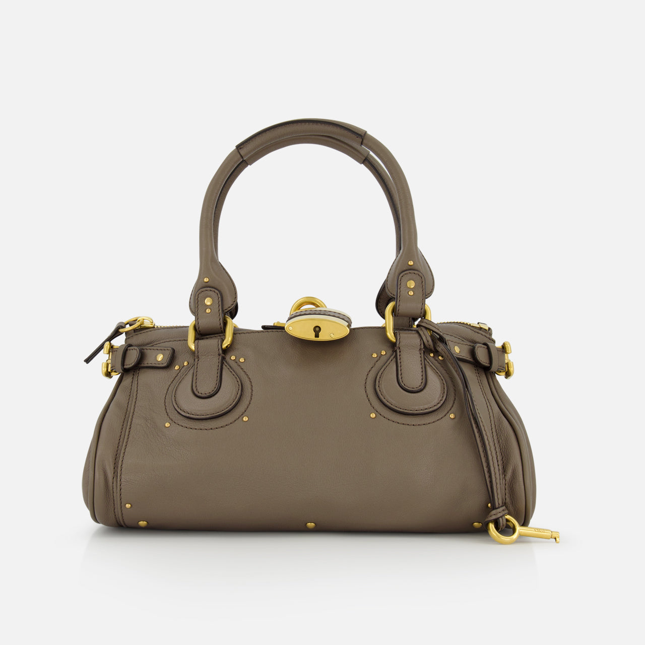 The CHLOÉ Paddington Shoulder Bag in taupe buffalo leather features double handles, gold hardware, and decorative buckles, shown on a white background.