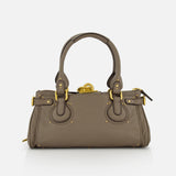The CHLOÉ Paddington Shoulder Bag is a taupe designer handbag made from buffalo leather with gold hardware, double handles, and decorative circular stitching, shown against a white background.