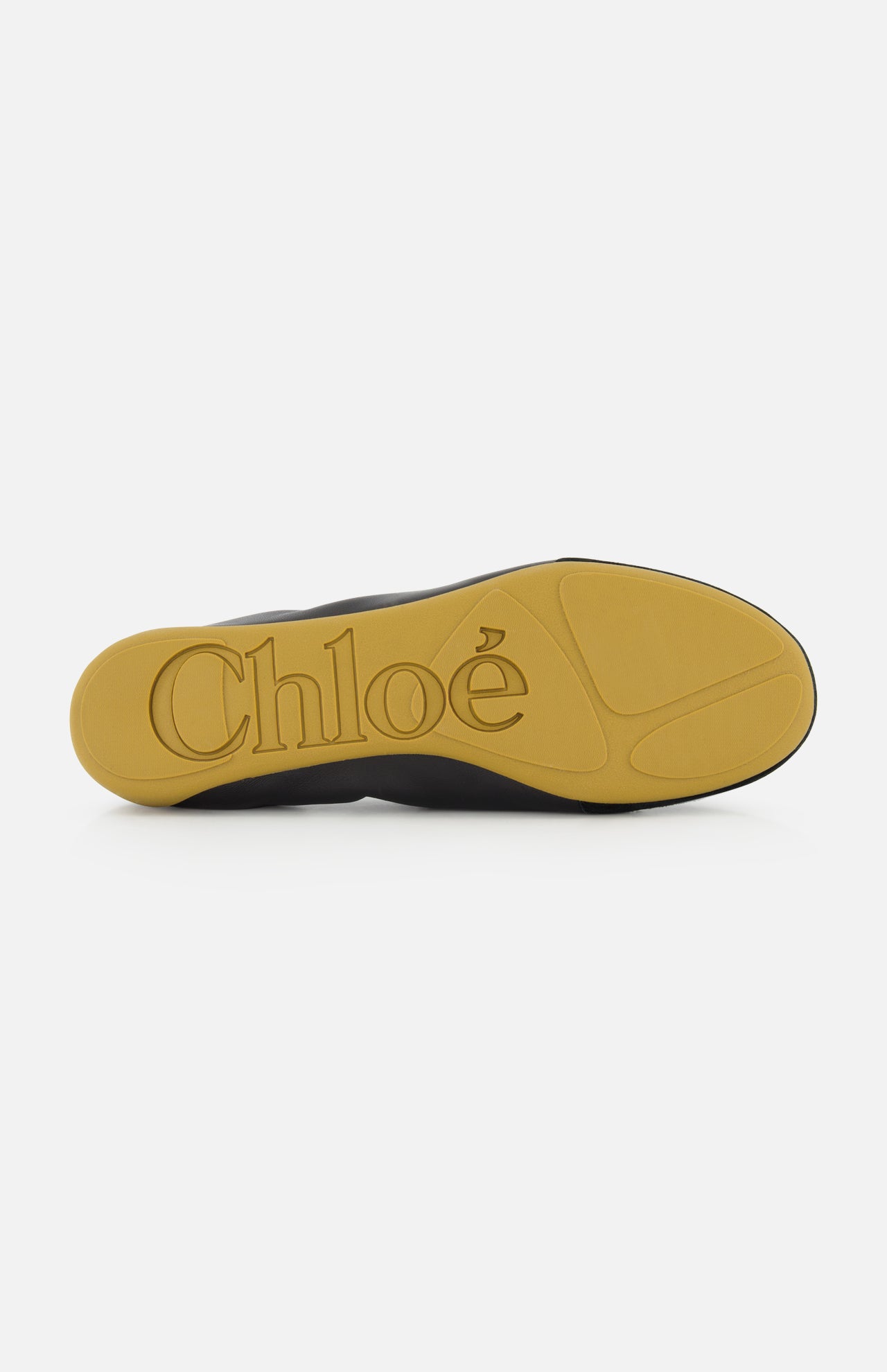 The image shows the yellow rubber sole of the CHLOÉ Laced Kick Flats, with "CHLOÉ" embossed in large letters. The rest of this black sporty ballet flat is only partially visible.