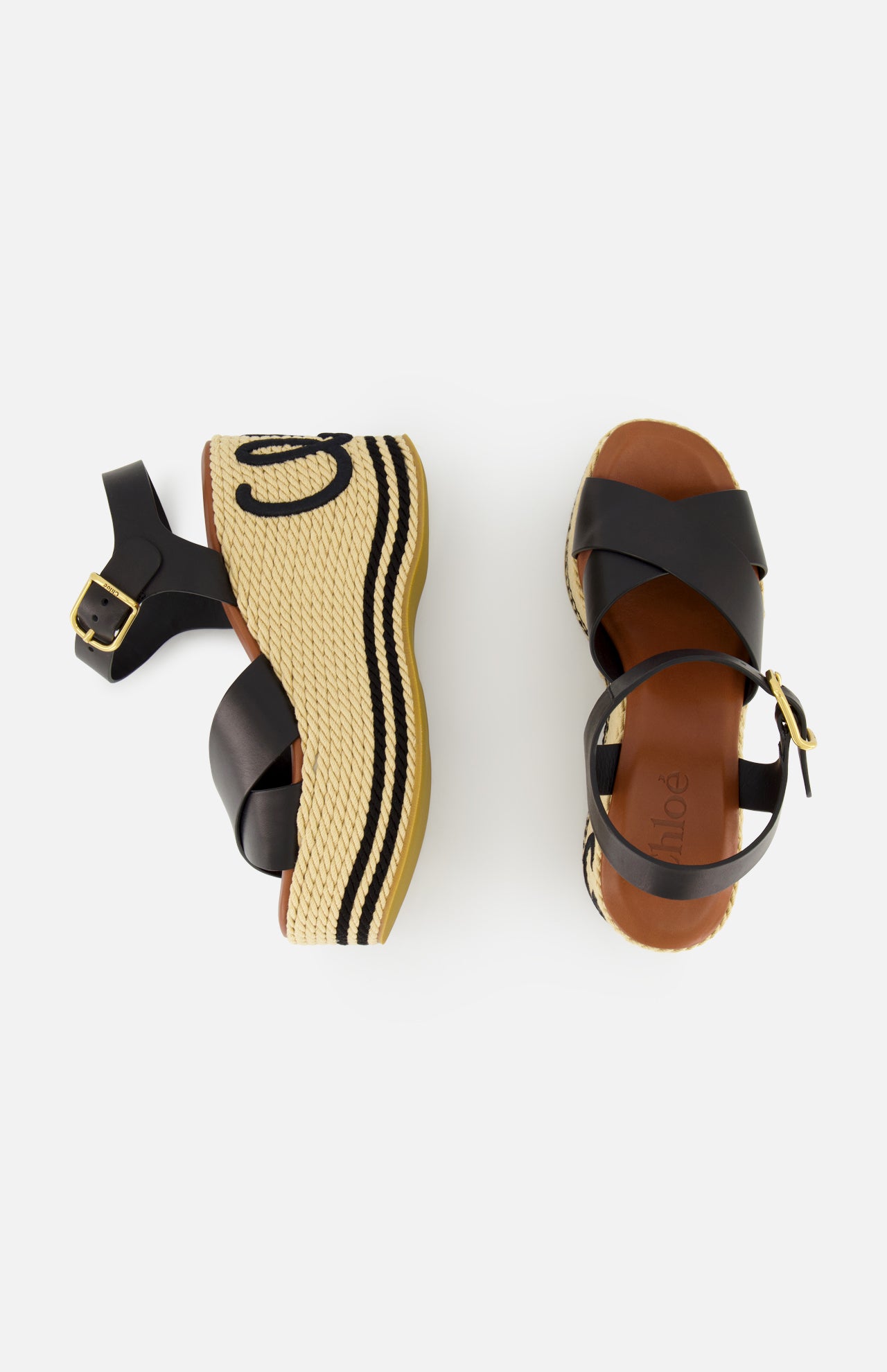 The CHLOÉ Chlóe Sand Wedge Heel features black leather straps, ankle buckles, and woven beige platforms with black wavy trim and stitched details. One sandal is shown from the side, the other from above.