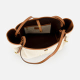Top view of the open Chloé Cotton Clover Bag by CHLOÉ, crafted from beige cotton with brown leather handles and trim, revealing a spacious dark-lined interior with a zippered pocket and an attached buttoned pouch—ideal as a chic designer office bag.