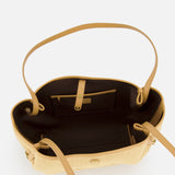 The CHLOÉ Raffia Clover Bag is a tan and beige woven raffia tote with leather trim, a brown interior lining, an inner zippered pocket, and an open compartment, shown from above.