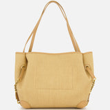 The Chloé Raffia Clover Bag by CHLOÉ features a tan woven raffia design with double shoulder straps, gold chain accents, leather-trimmed corners, and an exterior pocket—all set against a plain white background. This versatile bohemian tote is perfect for everyday style.