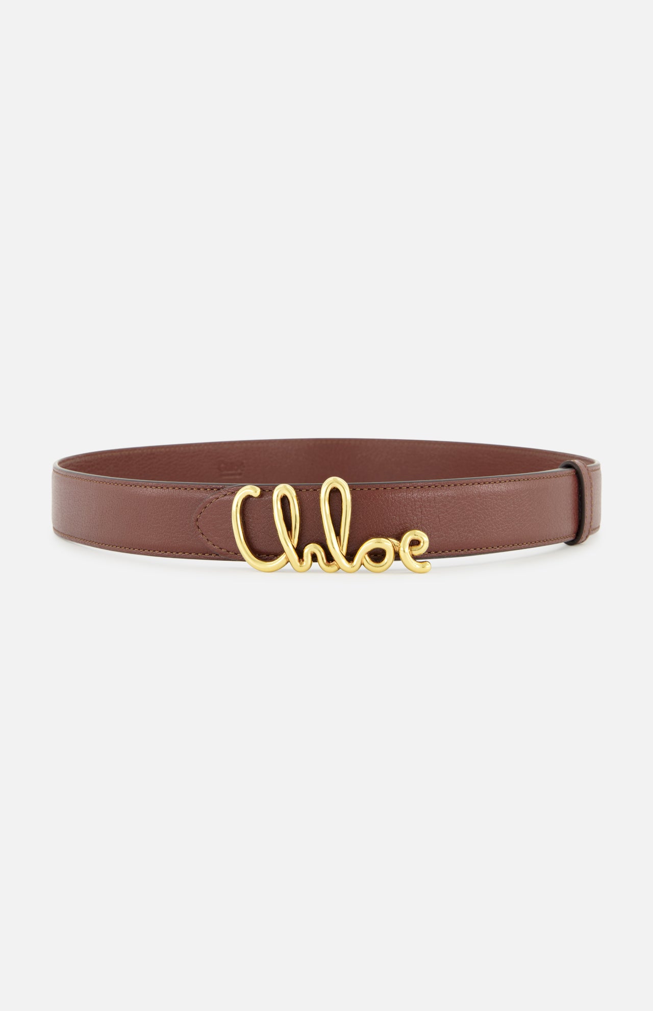 The Chloé Iconic Belt by CHLOÉ is a brown leather accessory with a gold buckle styled in the elegant cursive lettering of “Chloé,” showcased against a white background.