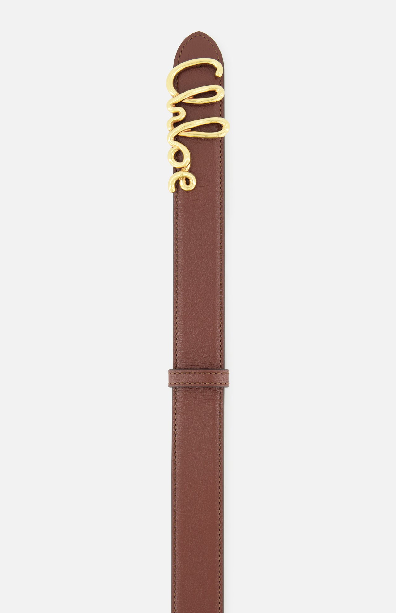 The Chloé Iconic Belt by CHLOÉ is crafted from rich brown leather and features a gold buckle elegantly shaped to spell out “Chloé” in cursive script, showcased against a white background.