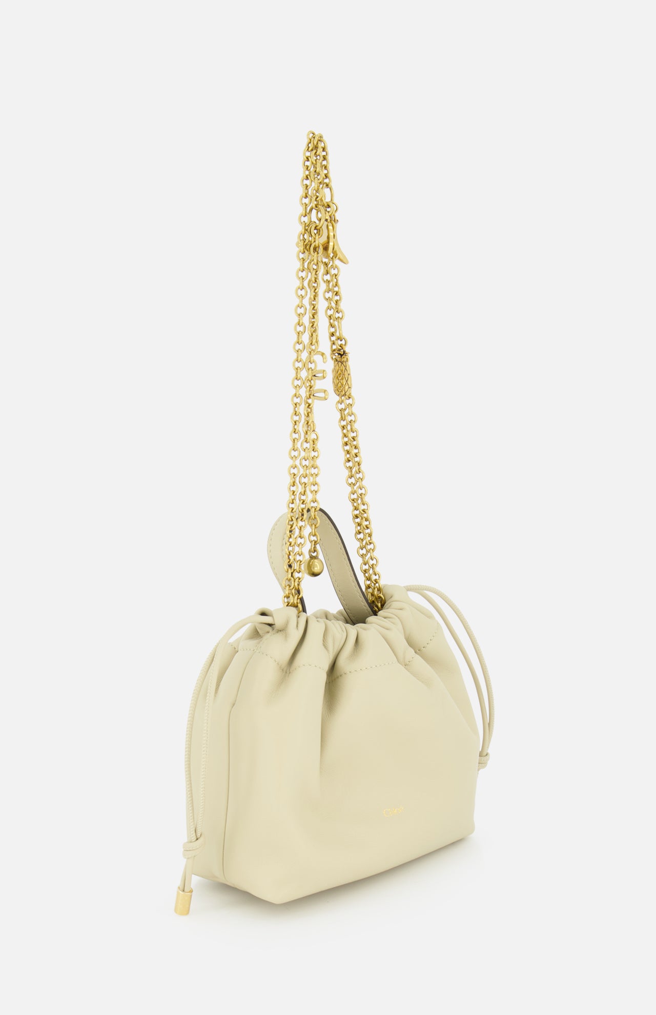 The Chloé Icons Chain Strap Bag by CHLOÉ is a small, cream-colored leather handbag featuring a drawstring top and a long, gold chain strap, displayed elegantly against a white background.