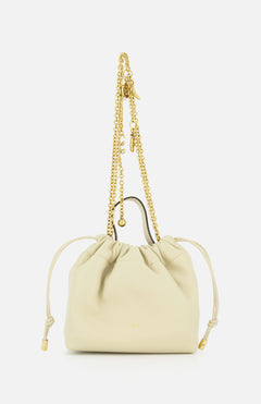 The CHLOÉ Chloé Icons Chain Strap Bag is a small cream leather handbag featuring slim side ties and a decorative gold chain handle embellished with charms, shown against a white background. This elegant mini shoulder bag exudes refined simplicity, echoing the timeless, effortless style characteristic of CHLOÉ.