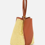 The CHLOÉ Woven Panels Spin Bag is a stylish bucket bag with brown leather panels, textured yellow woven sides, a gold chain with decorative charm, and double leather handles.