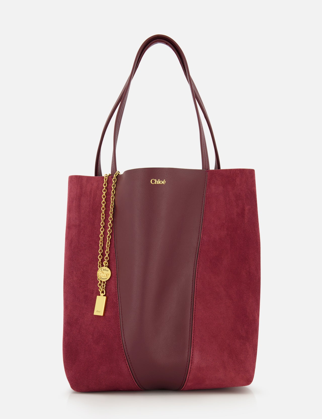 A CHLOÉ Leather and Suede Spin Bag in burgundy, featuring leather and suede panels, gold chain and padlock charm, double handles, and a removable bag chain for added versatility. Displayed against a plain white background.