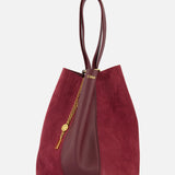 The CHLOÉ Leather and Suede Spin Bag is a burgundy tote featuring double handles, crafted from a mix of suede and leather. It showcases a stylish removable bag chain, an elegant gold medallion detail, and a subtle gold logo near the top.