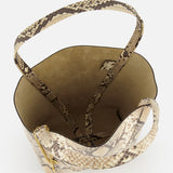 A top-down view of the CHLOÉ Spin Bag with Chain shows its snakeskin print in beige and brown hues, spacious light brown interior, and shoulder straps.