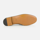 The image shows the sole of the CHLOÉ Letti Gold Heart Loafers, crafted in brown leather with a black heel. Near the arch, “CHLOÉ” and the size 37 are embossed, showcasing the brand’s signature attention to detail found in their feminine footwear.